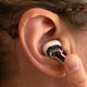 The stem features touch controls on the flat side. Sliding your finger up and down increases and decreases volume, but there are tap controls as well for controlling music playback and quick access to other functions.
